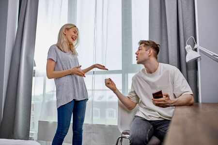 wife does not have enough attention from her husband, he always sits with the phone. unhappy woman want to get some attention and affection from husbandの写真素材