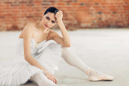 thoughtful awesome dancer in stylish white tutu looking at the camera, free time. leisure time, spare timeの写真素材