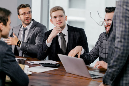 leadership and business concept. business team in modern office sit having active discussion of...