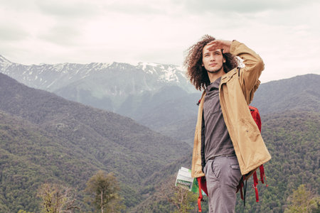 man looks ahead into distance with mountains