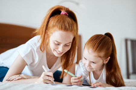 family, children and happy people concept - Close-up view of beautiful caucasian red-haired mother...