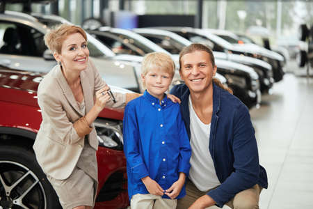 Happy family near new car. Auto dealership centreの写真素材