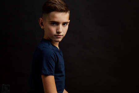 Portrait of little boy on black backgroundの写真素材