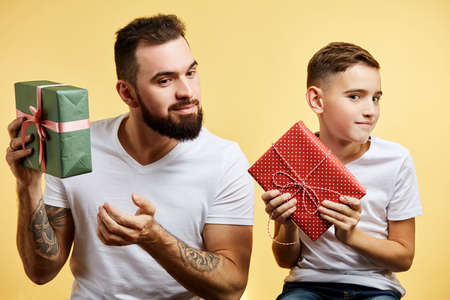 Happy son and father gives gift to each other. Fathers day, family holiday, vacationの写真素材