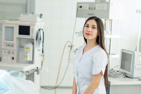 good looking brunette female intern in the hospital. close up photo. copy space. educationの写真素材