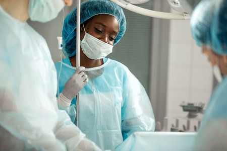 good looking awesome nurse enjoying her job. assistant having a rest during surgery.