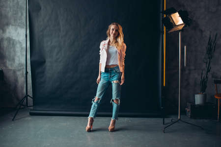 Beautiful attracive model with long fair hair posing in photo studio.full length photo, beauty conceptの写真素材