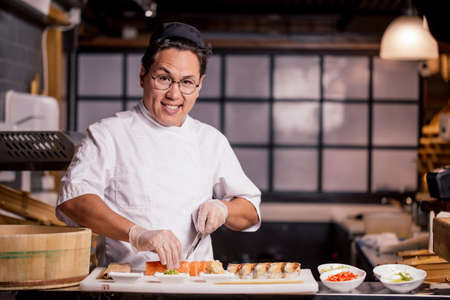 gorgeous attractive man with raised eyebrows posing to the camera in the kitchen. copy spaceの写真素材
