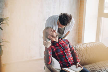 Romantic hot male same-sex couple enjoy togetherness, kiss each other, feeling passion and desire. Mutual alternative love.の写真素材