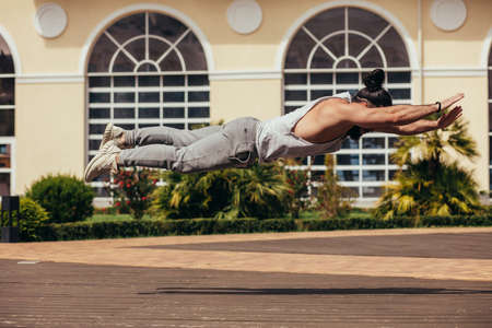 Extreme push-up - Fitness man with beard doing crossfit training outdoors showing power and strength .の写真素材