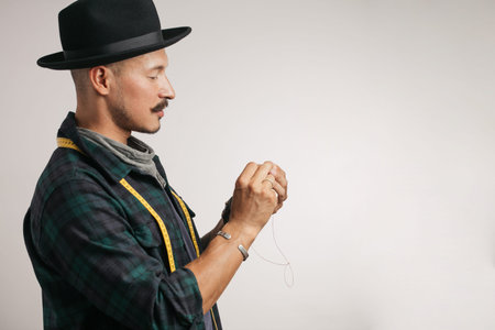 Leather handbag craftsman at work in a workshop, isolated studio photo