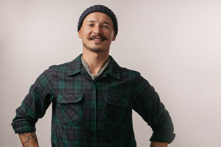Portrait of kind cheerful smart professional friendly expert handsome handyman wearing knitted hat...