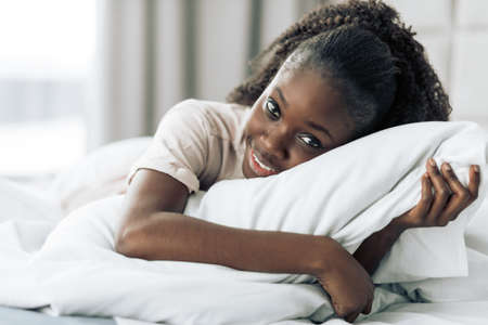 happy carefree girl hugging her pillow. close up photo.love. girl fell in love .の写真素材