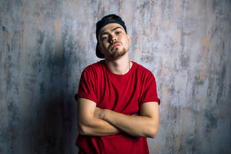 handsome man in fashion clothes posing to the camera. hip hop lovers, street art concept.の写真素材