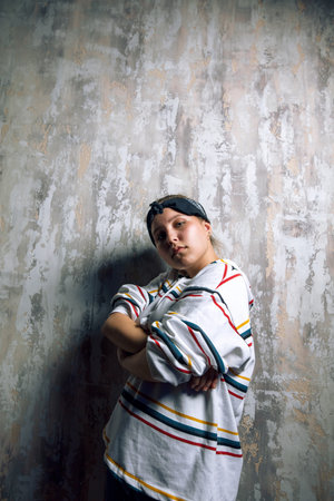 serious pleasant girl is interested in rap culture. music, dance concept. close up photo