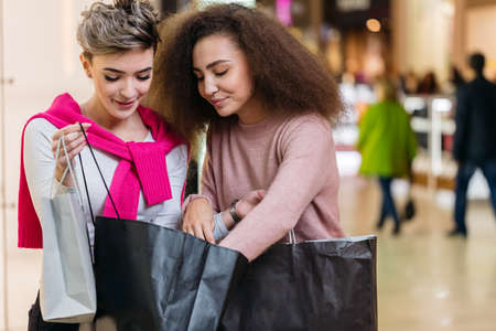 Portrait of two young woman shopping.の写真素材