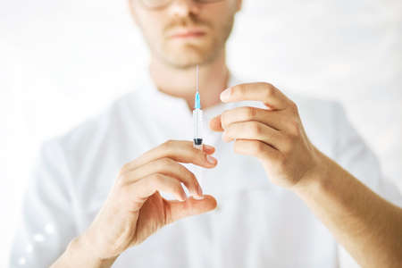 injection to induce anesthesia , close up cropped photo. maomebodn is going to give sy a needle. safety and efficacy of the vaccineの写真素材