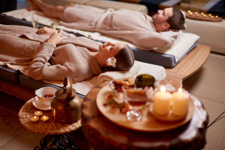 young man and woman, couple in love relaxing together at spa salon, after enjoying treatment, health and body care, holiday weekendの写真素材