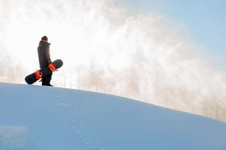 young man is standing on the top of the moubtain and enjoying beautiful nature. copy space. relaxation. weekend. holiday in the mountaines.の写真素材