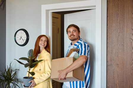 portrait of adorable lovely couple moved to a new apartment, they brought all the boxes of things....