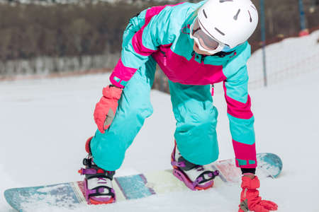 young woman having difficulties in sport, balance, girl concentrated on snowboarding, effort conceptの写真素材