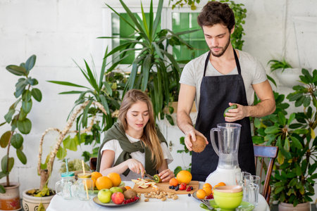 awesome man is choosing fresher fruits for homemade cocktail. close up photo
