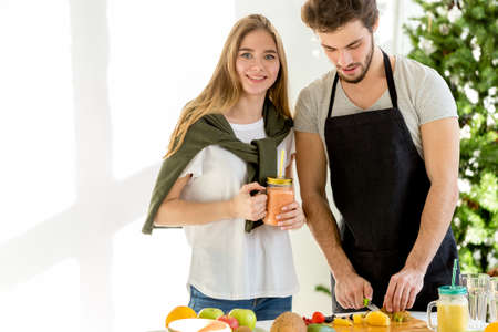 pretty stylish girl with blue eyes is posing to the caemra while her friend is working. close up shot. copy spaceの写真素材