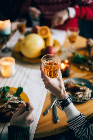 woman cheering relatives with champagne and wine. female holding a glass od juice. cropped photo