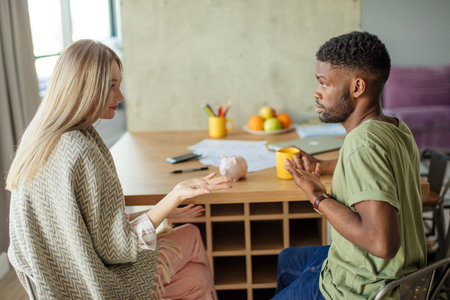 Caucasian blonde woman has some misunderstanding with her african hipster boyfriend, who is having...