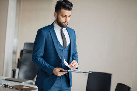 handsome awesome businessman with folder at work. close up photo.copy space.job, profession, managementの写真素材