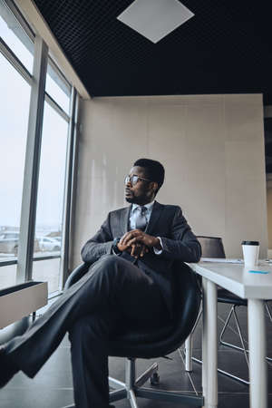 serious talented businessman is watching the street. resting leader of company.の写真素材