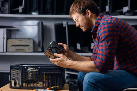 awesome computer repair technician repair hardware indoors, close up side view photo,の写真素材