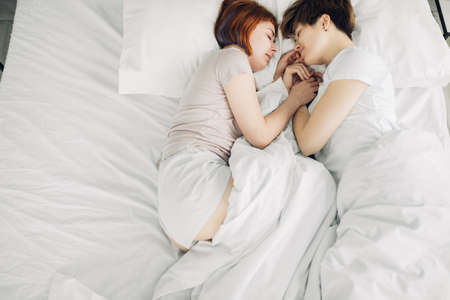affectiont. honosexual couple sleeping at home. copy space.laziness conceptの写真素材
