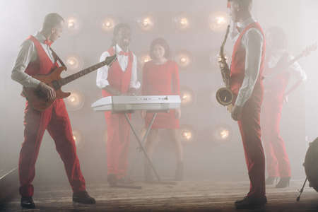 mixed race band practising their performance on the stage. close up photo.harmony, melodyfor soul, vocal techniquesの写真素材