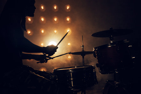rock party at night club. the silhouette of a musician in a dark room