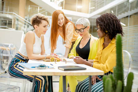 attractive cute women making up a plan how to improve sale. close up photo.competitive businessの写真素材