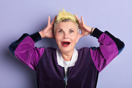 old woman being shocked after visiting hairdressing salon. close up portrait. studio shot. feeling...