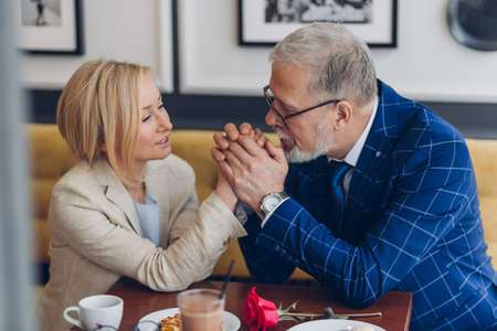 elegant man adores his woman. handsome man enjoying the time with his first love. meeting after many yearsの写真素材