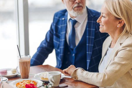 pleasant time with co-workers. man congratulating a woman with Mothers day. close up cropped photoの写真素材