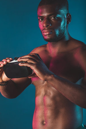 People, technology, sport and cyberspace concept. Isolated portrait of young dark-skinned man...