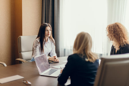 Woman job applicant having an interview with two female corporate experts at office of big company....