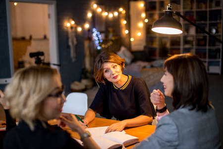 Deadline at Designer s Office. Attractive confident caucasian female Chief executive calls a late night meeting with her personal assistants at her office.の写真素材