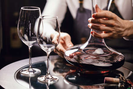 Staff training for sommelier experts. All that is needed is wine etiquette, the rules for buying wine for the customer, decanting and pouring wine into glasses.の写真素材