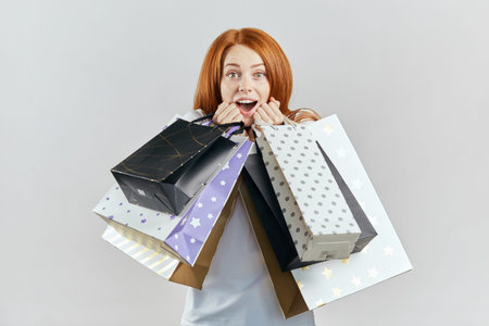 excited girl is happy as she bought a lot of things. black friday. shopping season. studio shot