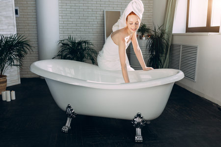 Content attractive young tourist female pampering herself with mineral water procedure in wellbeing...