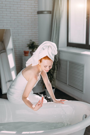 Content attractive young tourist female pampering herself with mineral water procedure in wellbeing...