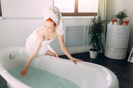 Content attractive young tourist female pampering herself with mineral water procedure in wellbeing...