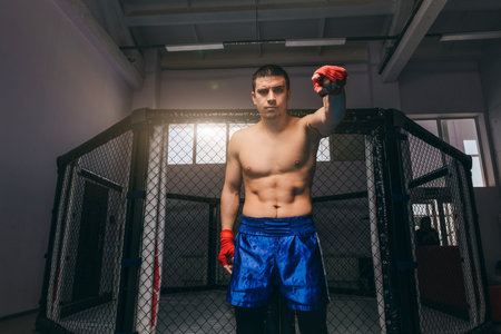 Portrait of young male boxer with strong naked torso