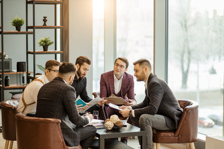 young leaders of business company coworking in office, dressed in formal wear, keep records and...