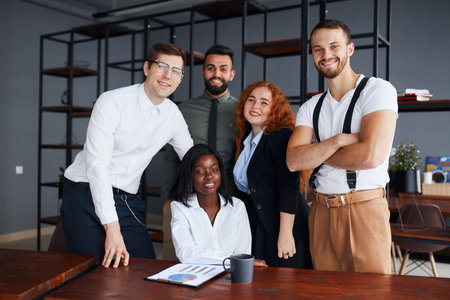 Portrait of joined group of people working together, multi-ethnic business co-working in modern...